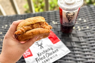 a person holding up a kfc chicken sandwich