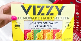 a person holding vizzy hard seltzers in a target