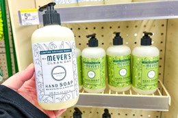 hand holding hand soap bottle