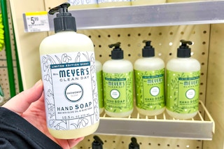 hand holding hand soap bottle