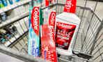three toothpastes and a bottle of mouthwash in shopping cart