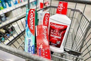 three toothpastes and a bottle of mouthwash in shopping cart