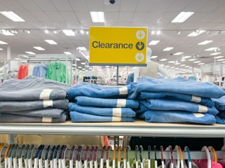 a yellow clearance sign above jeans