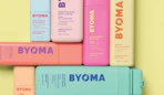 colorful bottles of skincare on a butter yellow background