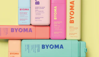 colorful bottles of skincare on a butter yellow background