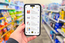 hand holding a smartphone displaying 1-clip coupons in the kcl app