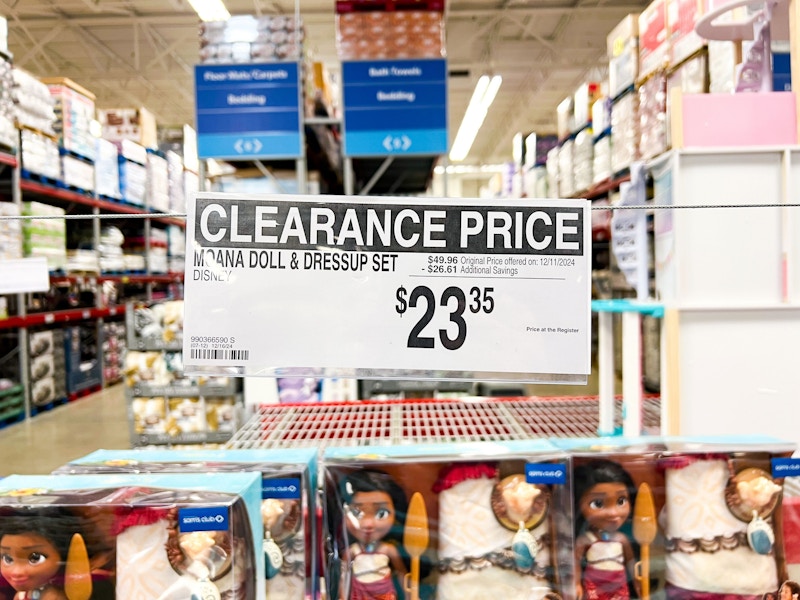 clearance sign for moana doll and dress up set for $23.35 hanging over the sets