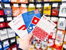 hand holding gift cards of CVS, doordash, dominoes