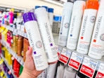 hand holding paul mitchell hair care items in cvs