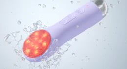 a purple LED cleansing brush in water