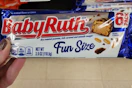 hand holding a pack of baby ruth fun size bars