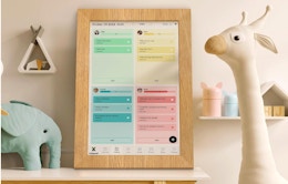 a wooden frame digital wall calendar on a table in a nursery 