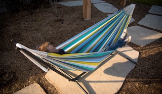 stock photo of man relaxing in vivere double hammock with stand