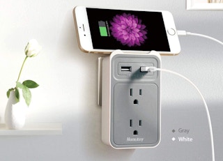 grey outlet extender with a phone on top