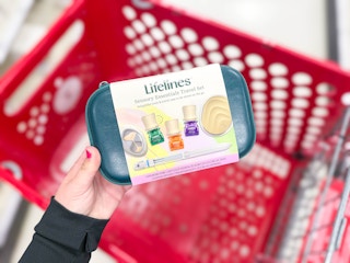 hand holding a lifelines travel set over a target cart