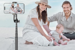 a woman and man taking family tripod photos