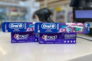 crest 3d white stain eraser toothpaste and oral-b vivid whitening toothbrush on a checkout counter
