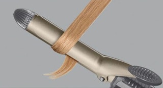 a curling iron curling a section of hair