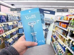 hand holding gillette and venus razors in walgreens