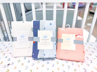 cloud island bedding sitting in a crib at target