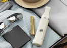 a bikini trimmer in a suitcase with clothes, makeup, and sunglasses