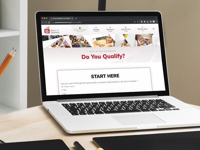 a laptop displaying the webpage on Pets in the Classroom's site about qualifying for grants