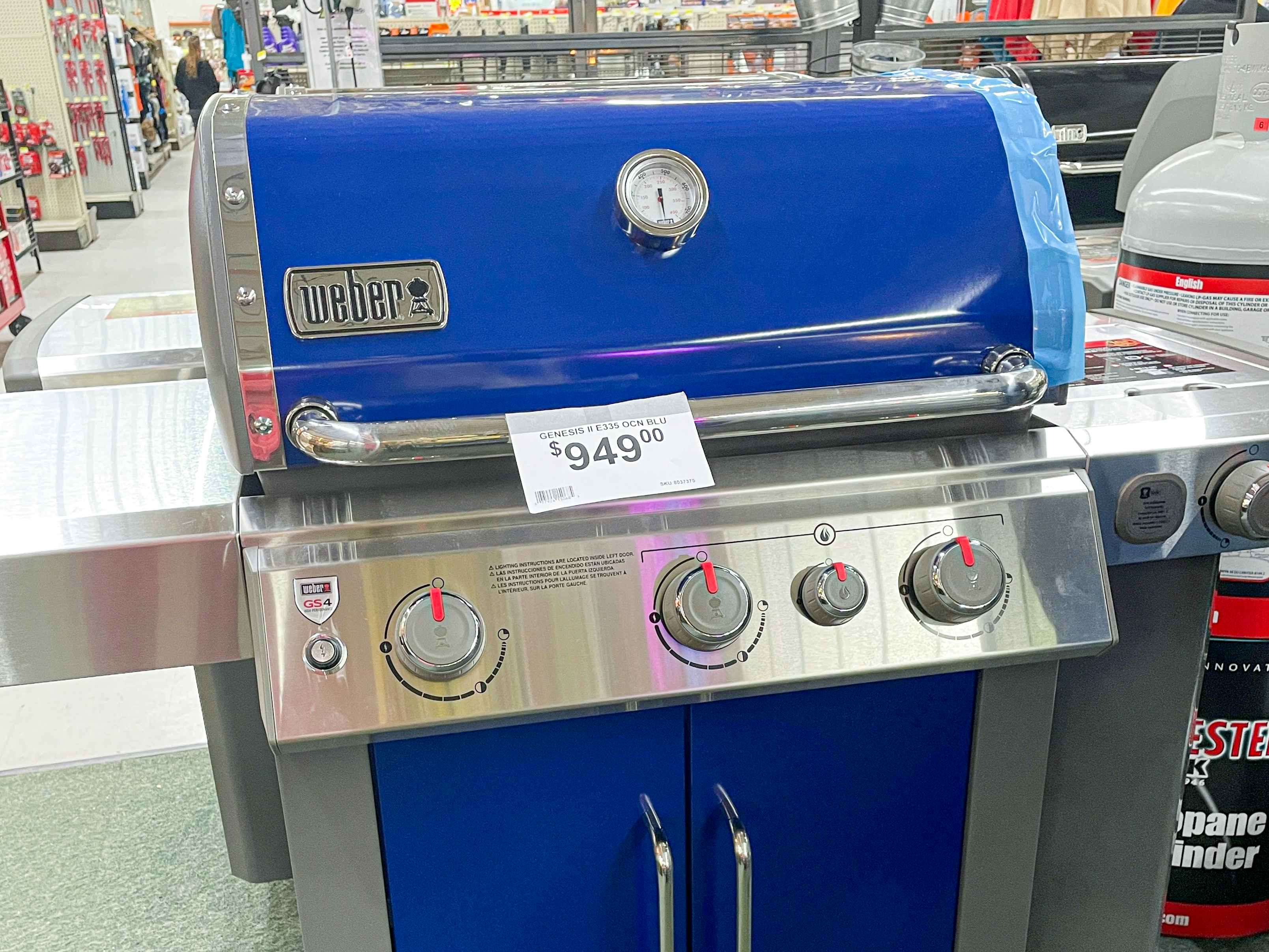 a blue weber grill at ace hardware with a $949 price tag on it