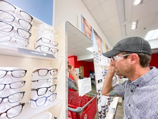 man trying frames in target optical