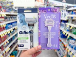 hand holding gillette and venus razors in walgreens