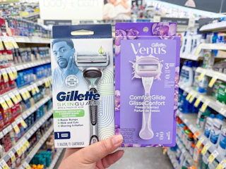hand holding gillette and venus razors in walgreens