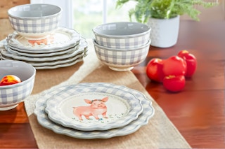 Lifestyle image of The Pioneer Woman Gingham 12-Piece Dinnerware Set displayed on wooden table