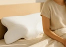 a cervical neck pillow on a bed