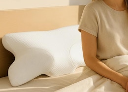 a cervical neck pillow on a bed