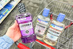 hand holding a bottle of listerine mouthwash