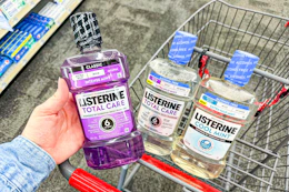 hand holding a bottle of listerine mouthwash