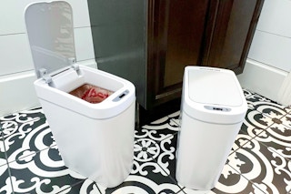 white motion sensor trash can next to a toilet