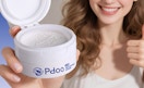 a person holding a jar with teeth whitening powder