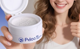 a person holding a jar with teeth whitening powder