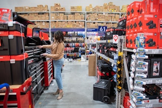 A woman looking at tool storage chests at the Lowe's store