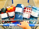 hand pushing walmart cart filled with mainstays fall fleece throws