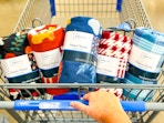 hand pushing walmart cart filled with mainstays fall fleece throws