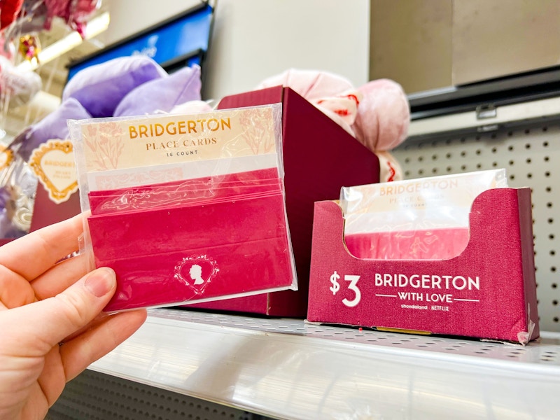 hand holding bridgerton placecards at walmart