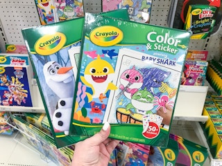 hand holding 2 crayola color and sticker books at target