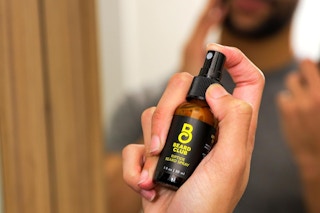 a man using the beard club beard riptide spray