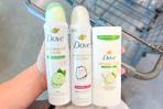 hand holding Dove deodorants over a shopping cart