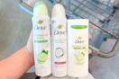 hand holding Dove deodorants over a shopping cart
