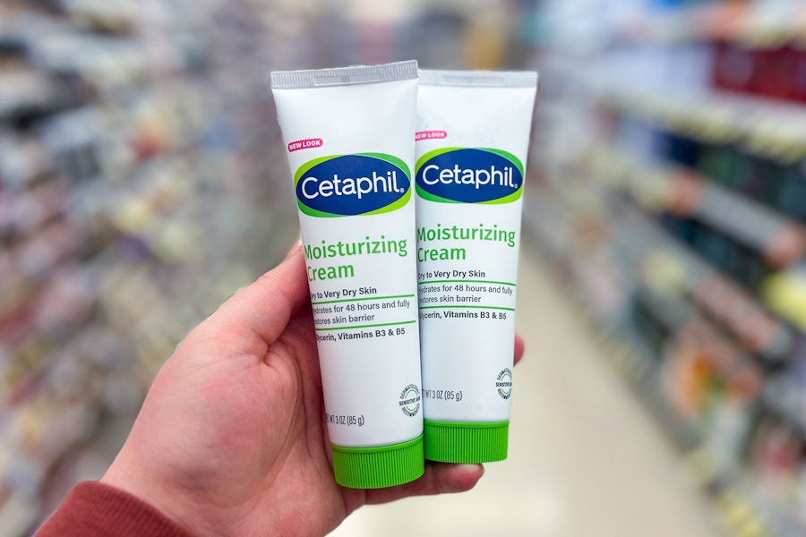 person holding 2 cetaphil creams in an aisle