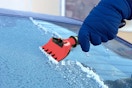 a hand using an ice scraper