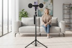 a woman facing a tripod