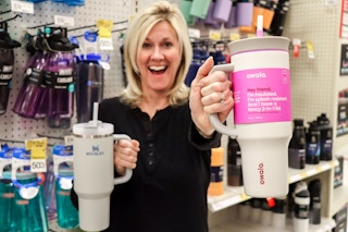 someone holding a stanley and a owala cup